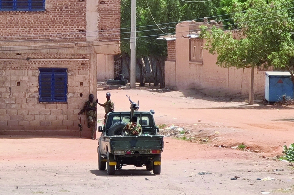Sudanese army soldiers rest next to a building in Khartoum. - AFP