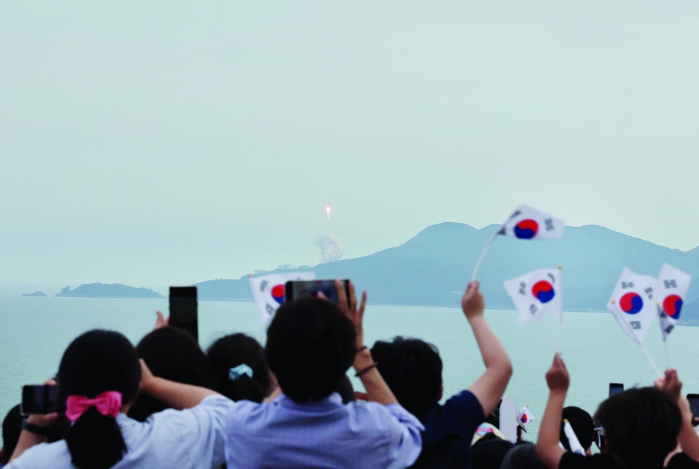 People watch the launch of South Korea’s homegrown Nuri space rocket in Goheung, South Korea. - Reuters

