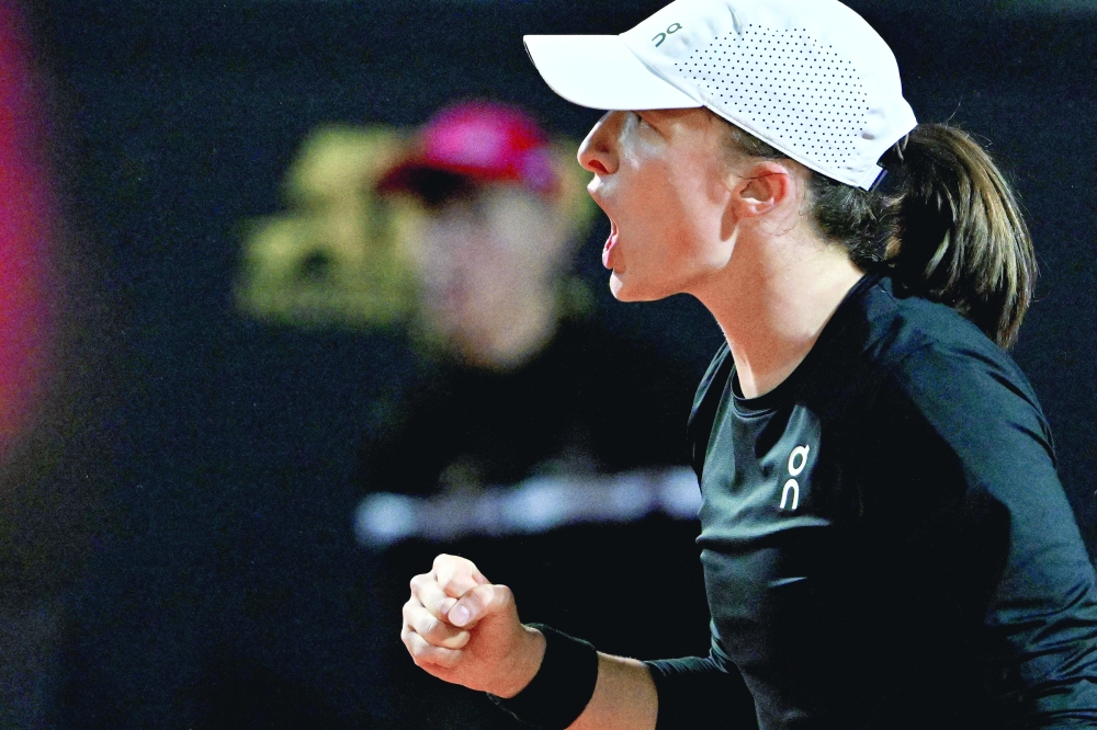 (FILES) Poland's Iga Swiatek reacts during her quarterfinals match of the Women's WTA Rome Open tennis tournament against Kazakhstan's Elena Rybakina, on May 17, 2023 at Foro Italico in Rome.  Iga Swiatek can become the first back-to-back women's champion at the French Open in 16 years if she can shake off a worrying injury. (Photo by Tiziana FABI / AFP)