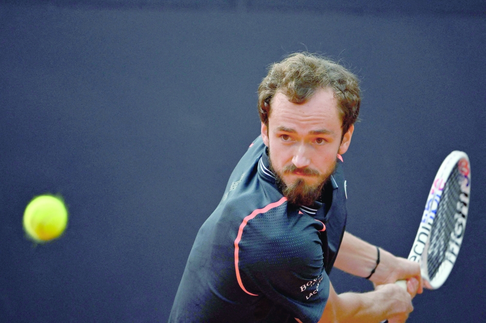 Russia's Daniil Medvedev plays a backhand return to Denmark's Holger Rune during the final of the Men's ATP Rome Open tennis tournament on the central court of Foro Italico in Rome on May 21, 2023. (Photo by Tiziana FABI / AFP / )

