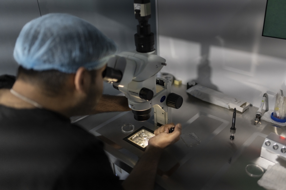 An embryologist prepares an embryo at the Newlife Fertility Center in Siliguri, West Bengal, India, on April 29, 2023. (Smita Sharma/The New York Times)