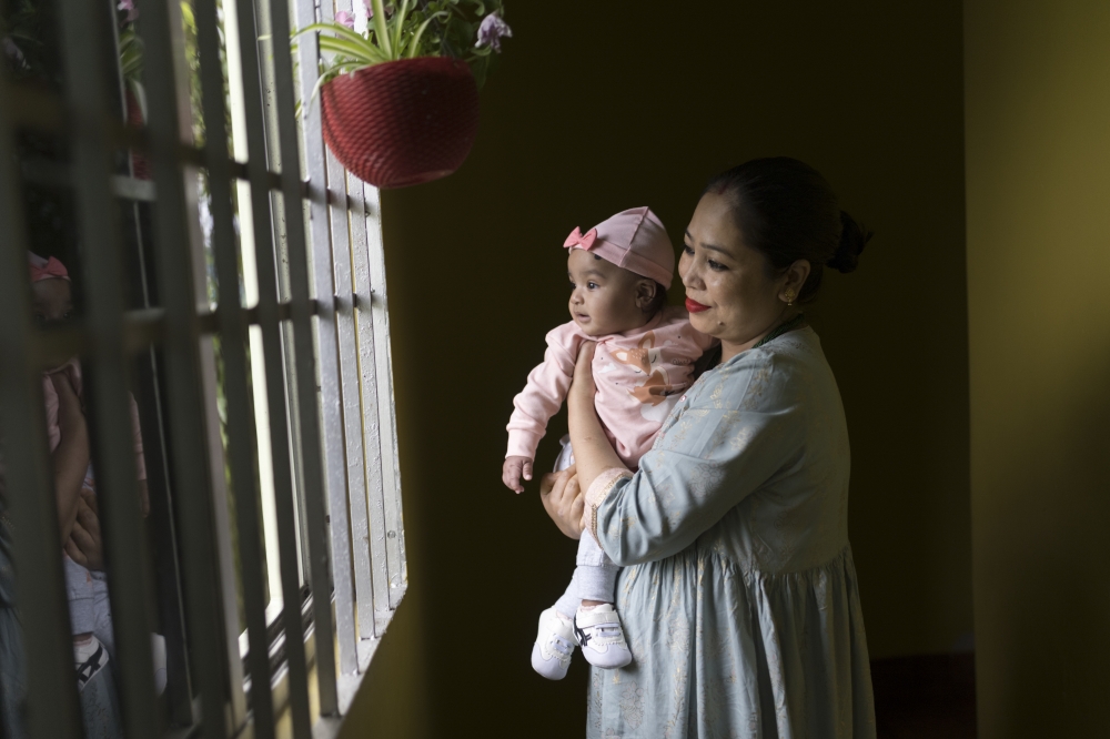 Arpana Chettri with her six-month-old daughter at her parent's home near Gangtok, in the Himalayan state of Sikkim, India, on May 1, 2023. (Smita Sharma/The New York Times)