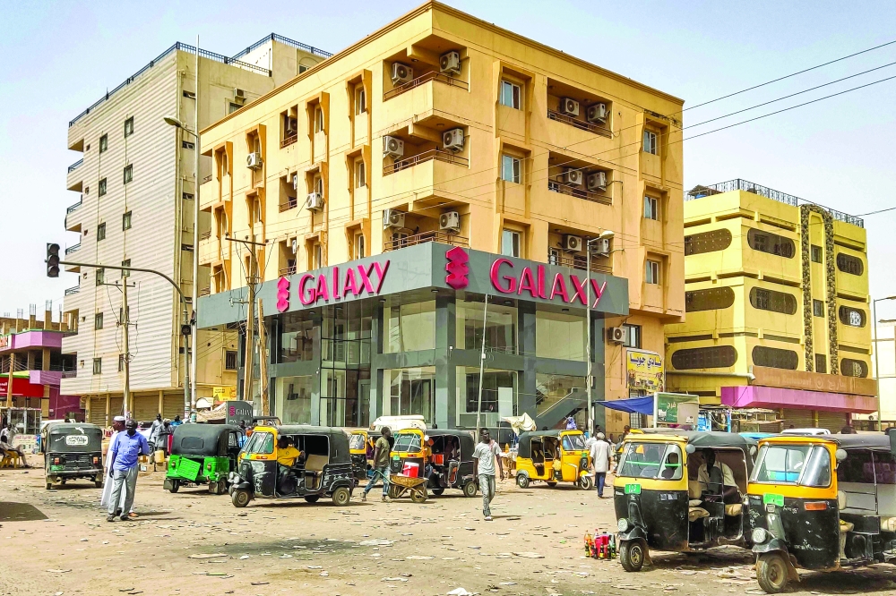 Tuk-tuks (motorised rickshaws) wait for passengers along al-Sittin road in the south of Khartoum. — AFP 