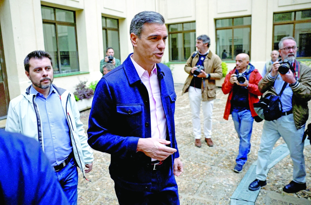 Spain's PM Pedro Sanchez appears after he casts his vote at a polling station during Regional elections, in Madrid. — Reuters 
