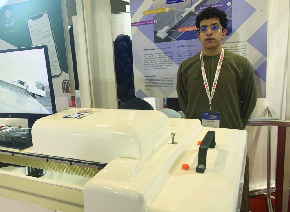 Hilal al Hashmi, co-founder of Dymuma Advanced Projects, with a prototype of his solar PV self-cleaning robot at COMEX 2023.