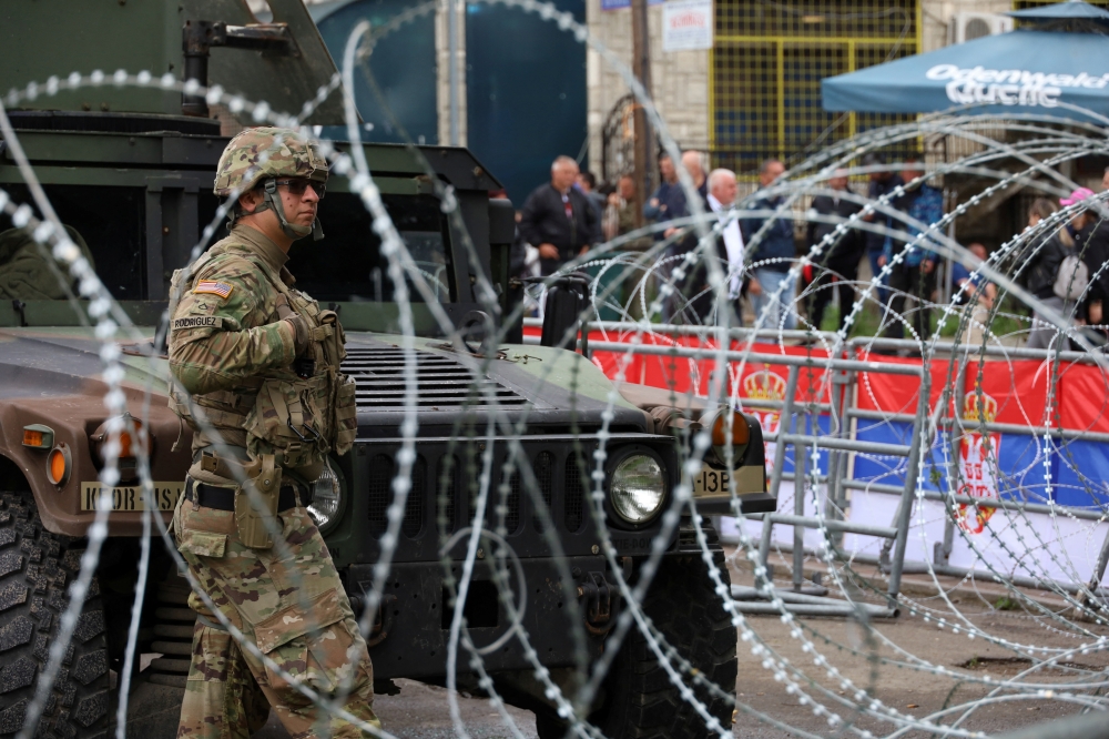 A U.S. Kosovo Force (KFOR) soldier, under NATO, stands guard near a municipal office in Leposavic, Kosovo. — Reuters 
