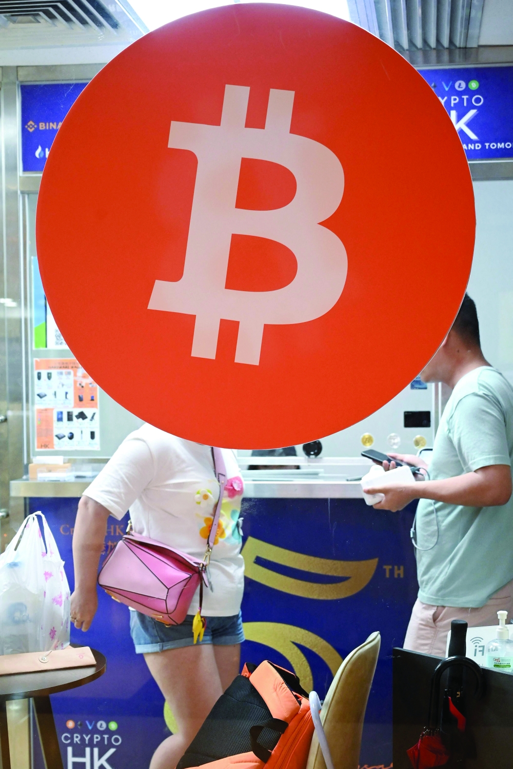 Customers in a cryptocurrency exchange office in Hong Kong. - AFP
