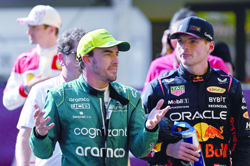 Pole position winner Red Bull Racing's Dutch driver Max Verstappen (R) and grid second-placed Aston Martin's Spanish driver Fernando (L)  speaks after the qualifying sessions of the Formula One Monaco Grand Prix at the Monaco street circuit in Monaco, on May 27, 2023. (Photo by ANDREJ ISAKOVIC / AFP)