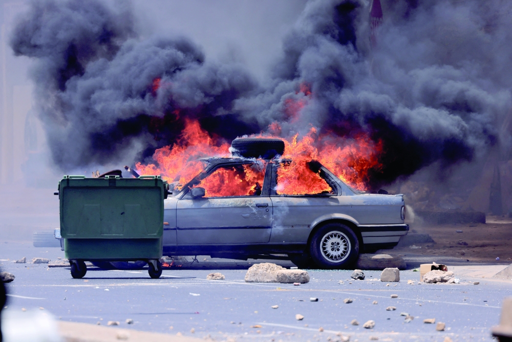 A car burns during clashes between security forces and students and supporters of Senegal opposition leader Ousmane Sonko, after Sonko was sentenced to prison in Dakar. - Reuters