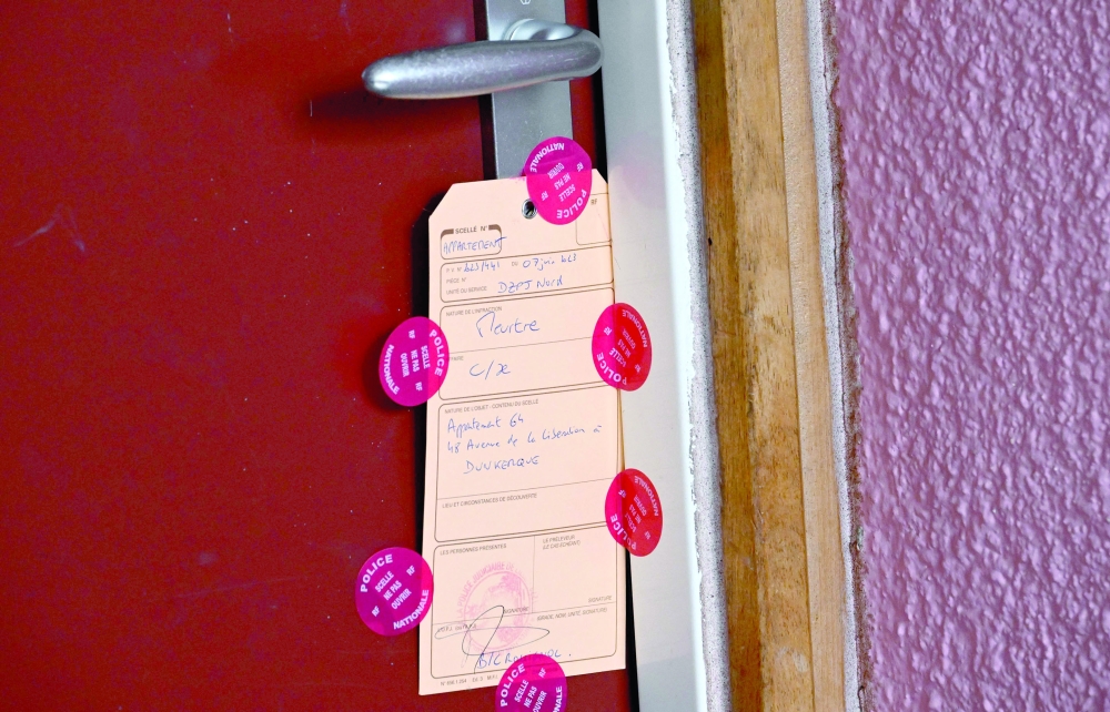 The door of the apartment, where the mother of a missing young girl has been found dead, sealed by French police, in Dunkirk, northern France. - AFP