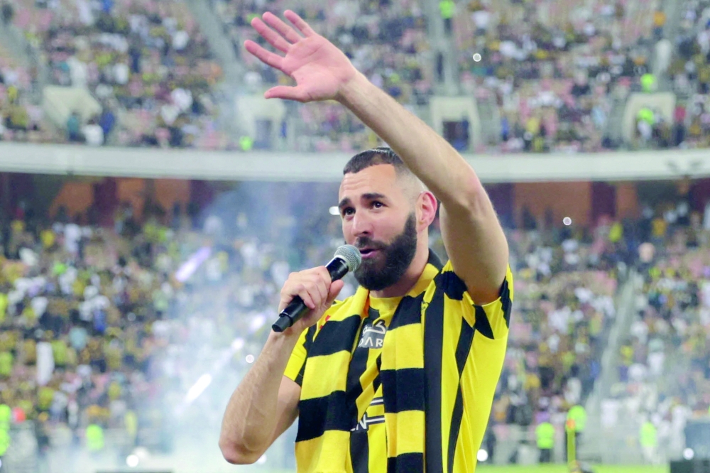 French forward Karim Benzema greets the crowd during his unveiling at King Abdullah Sports City stadium in Jeddah, on June 8, 2023. Benzema was unveiled as an Al-Ittihad player in front of thousands of fans in Saudi Arabia on June 8, a day after the oil-rich kingdom just failed to reel in Lionel Messi. (Photo by AFP)


