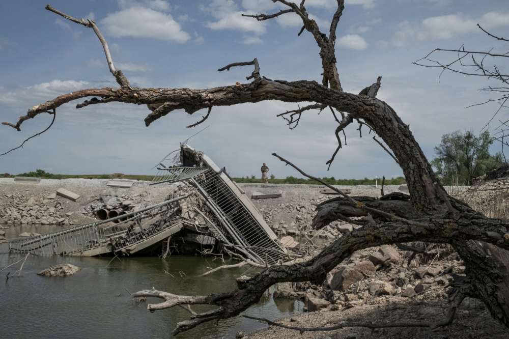 A bridge that collapsed into the water in the Kakhovka dam reservoir after the dam was breached, in the Kherson region of Ukraine, June 6, 2023. (Mauricio Lima/The New York Times)