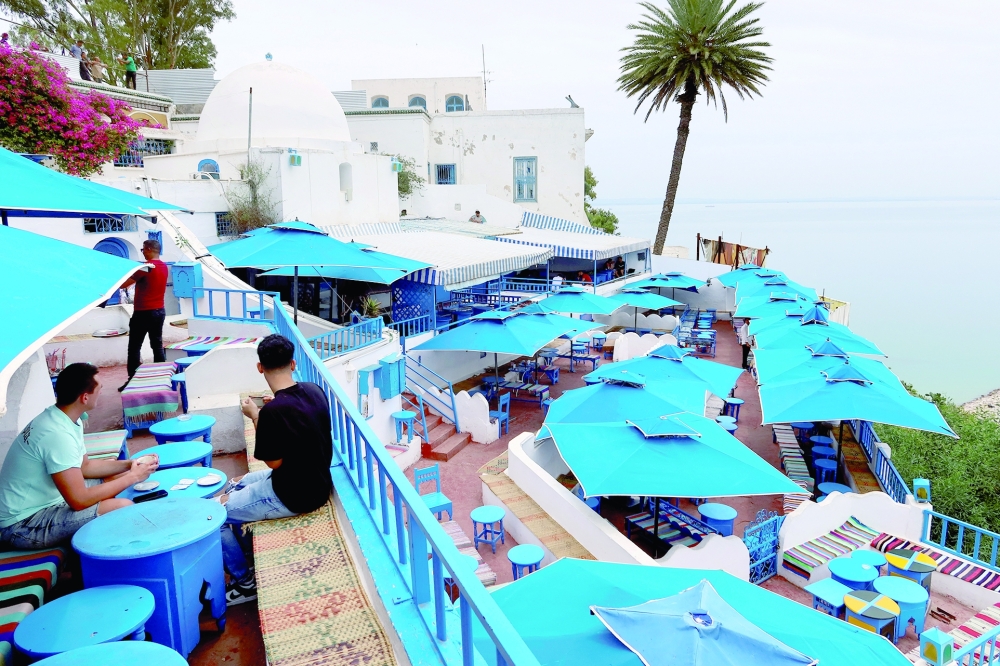 People sit in a cafe in Sidi Bou Said, a popular tourist destination near Tunis. - Reuters
