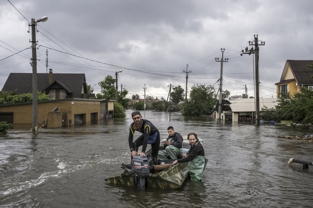 Volunteers on a mission to rescue animals and to deliver food to isolated residents, in an area flooded by the destruction of a dam in Kherson, southern Ukraine.