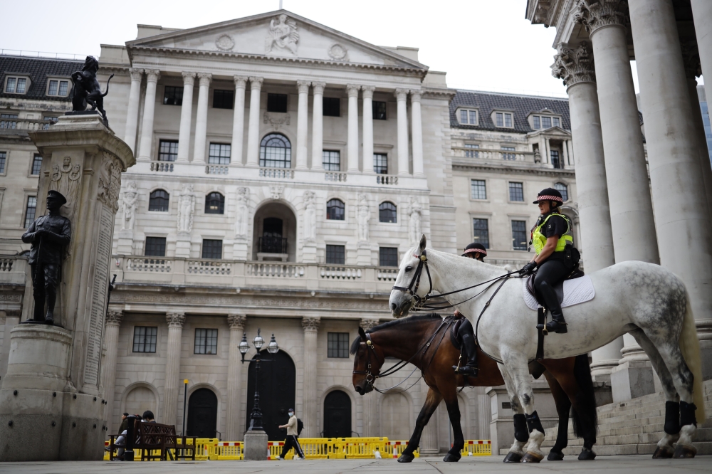 Mounted police officers sit in outside the Royal Exchange and the Bank of England in London. — Reuters