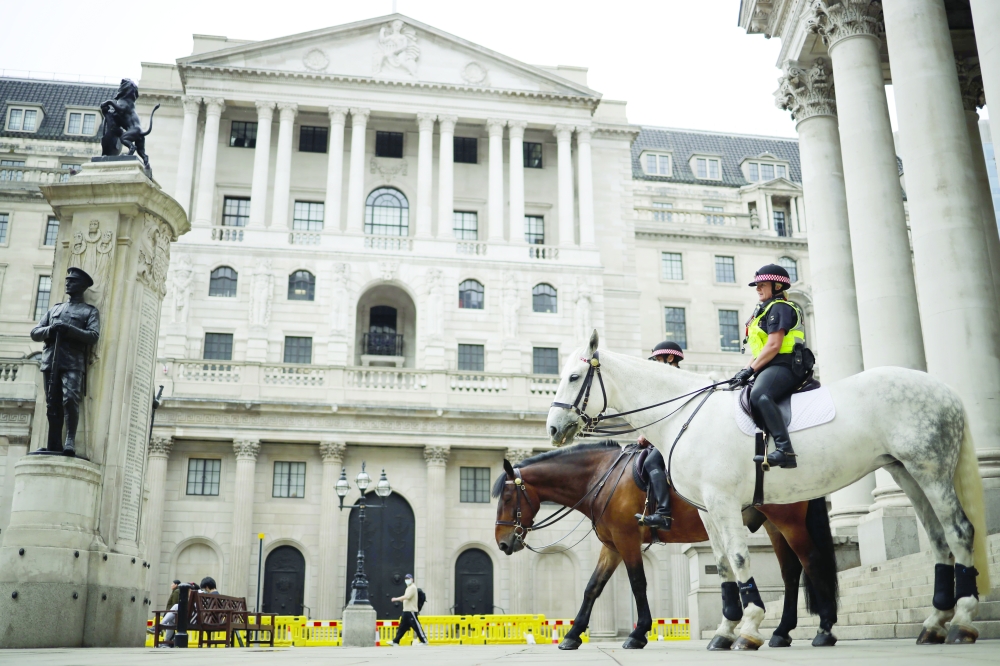 Mounted police officers sit in outside the Royal Exchange and the Bank of England in London. — Reuters