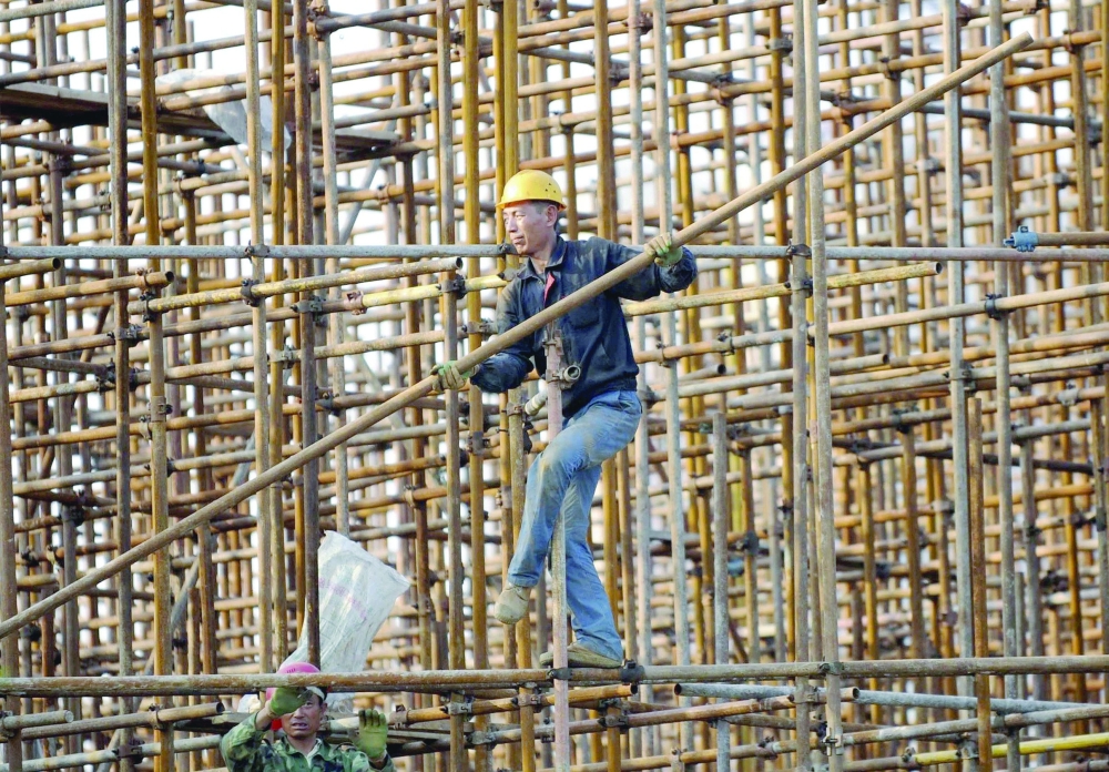 A man works at a construction site in Beijing. — Reuters