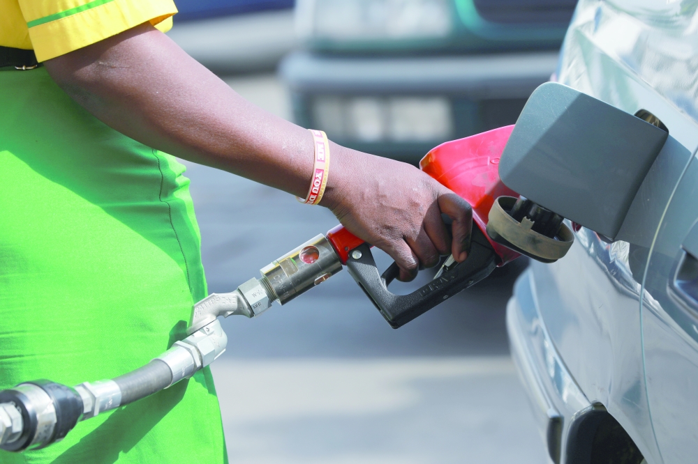 A gas station attendant pumps fuel into a customer's car at a petrol station in Abuja, Nigeria. — Reuters