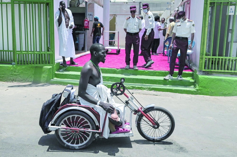 A disabled Muslim pilgrim arrives in Mina. — AFP 