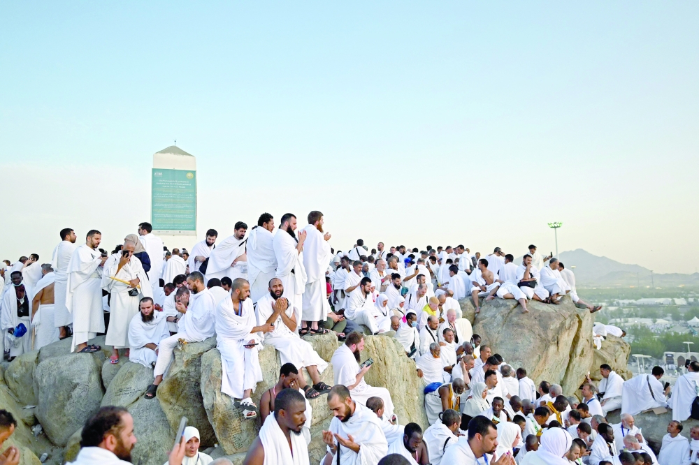Muslim pilgrims pray atop Mount Arafat, also known as Jabal al-Rahma or Mount of Mercy, during the climax of the Haj pilgrimage. — AFP 