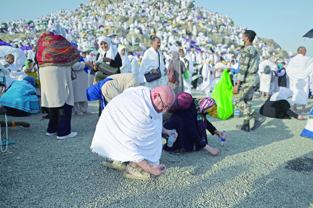 Muslim pilgrims collect pebbles at Saudi Arabia's Mount Arafat. — AFP 
