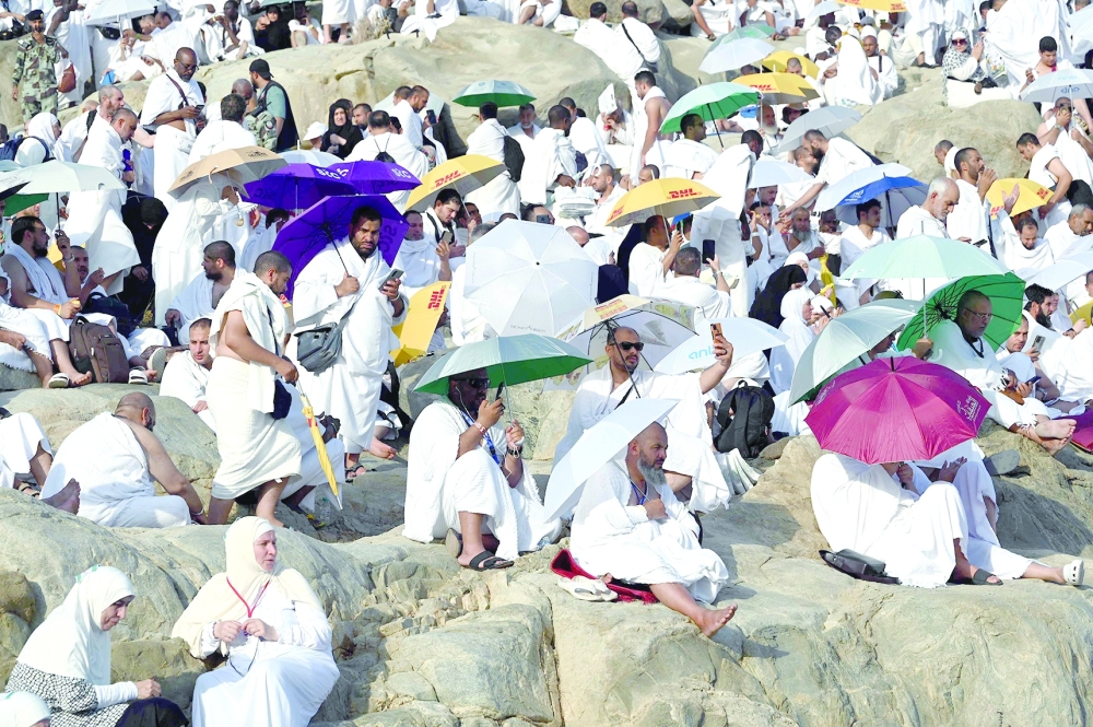 Muslim pilgrims pray atop Saudi Arabia's Mount Arafat during the climax of the Haj pilgrimage. — AFP