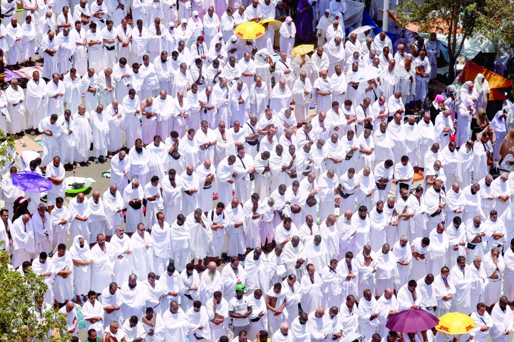 Muslim pilgrims attend the annual Haj pilgrimage outside Namira Mosque on the plain of Arafat, outside the holy city of Mecca. — Reuters