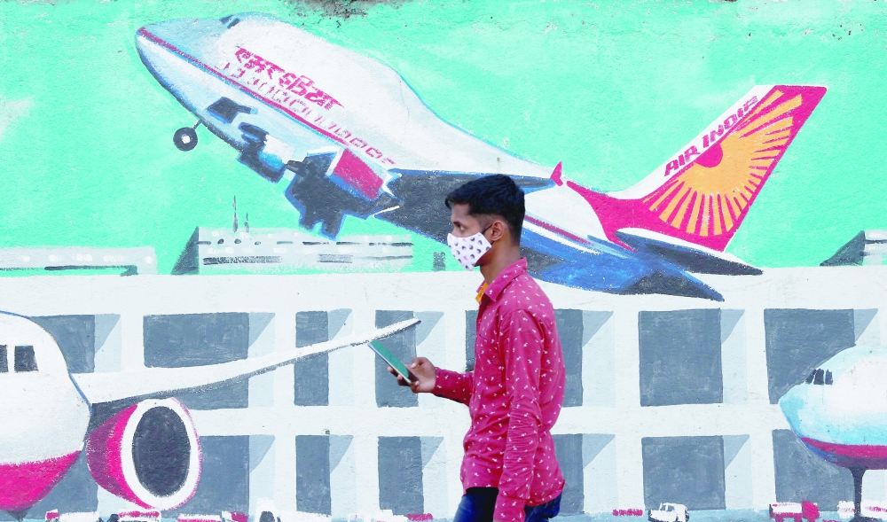 A man walks past a mural of Air India airlines on a street in Mumbai. — Reuters