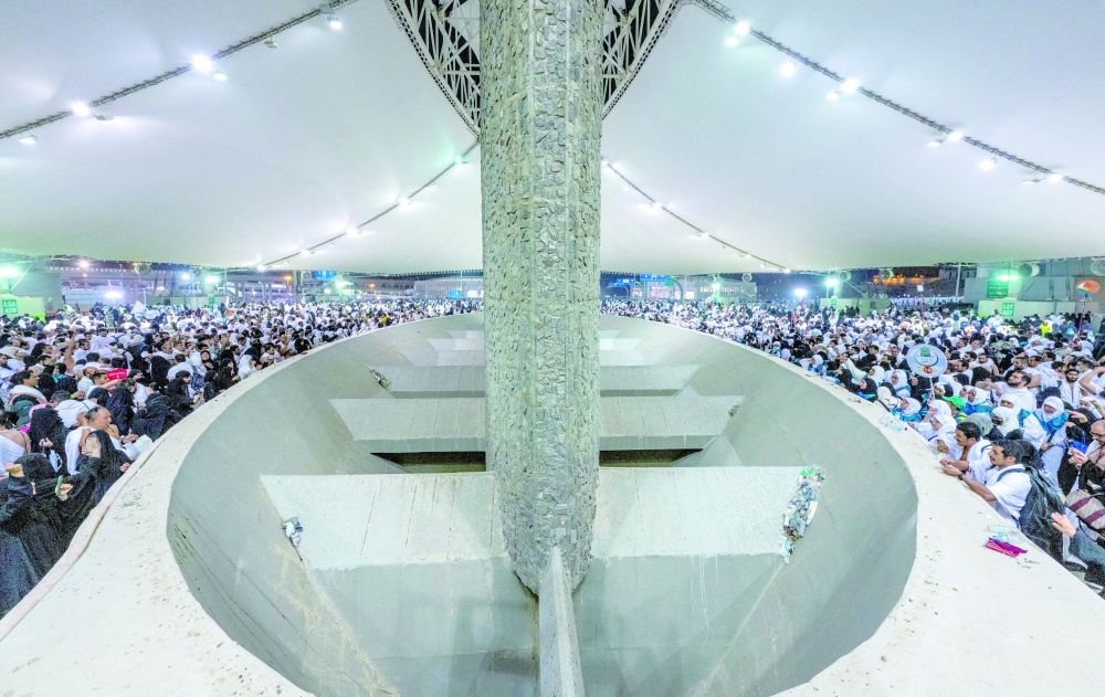 Pilgrims cast their stones at a pillar symbolising the stoning of Satan during the annual haj pilgrimage in Mina on Wednesday. — Reuters