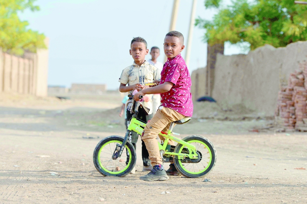 Sudanese children plays as worshippers who fled violence in Khartoum, gather to mark Eid in the region of Jazira, south of Khartoum. - AFP