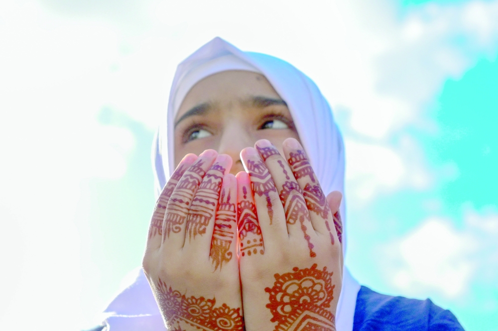 A devotee offers Eid al Adha prayers at the Galle Face in Colombo. - AFP

