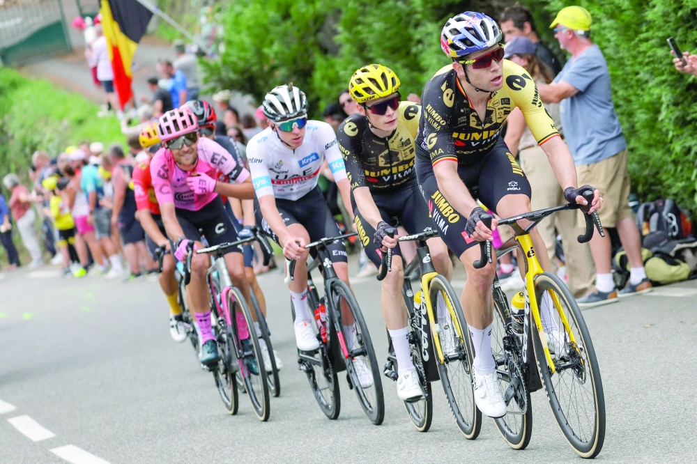 Jumbo-Visma's Belgian rider Wout Van Aert (R), Jumbo-Visma's Danish rider Jonas Vingegaard (2nd R), UAE Team Emirates' Slovenian rider Tadej Pogacar wearing the best young rider's white jersey (C) cycle in the ascent of the Col de Cauterets-Cambasque during the 6th stage of the 110th edition of the Tour de France cycling race, 145 km between Tarbes and Cauterets-Cambasque, in the Pyrenees mountains in southwestern France, on July 6, 2023. (Photo by Thomas SAMSON / AFP)

