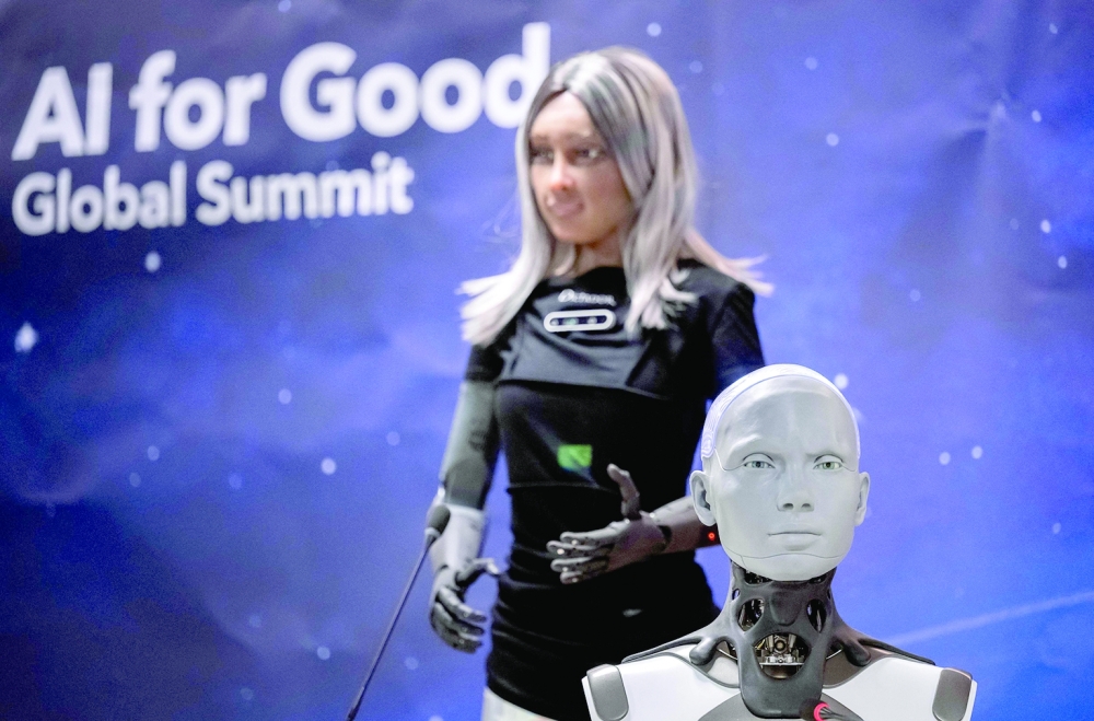 Humanoid AI robot Ameca (R) and CEO female robot Mika attend what was presented as the World's first press conference with a panel of AI-enabled humanoid social robots as part of International Telecommunication Union (ITU) AI for Good Global Summit in Geneva, on Saturday. — AFP