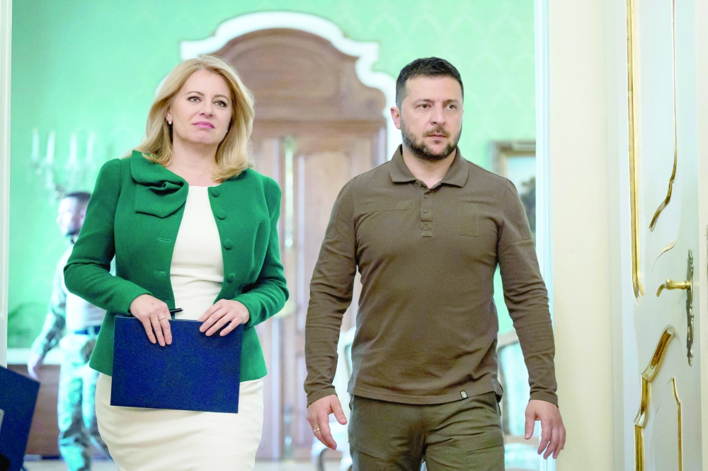 Slovak President Zuzana Caputova and Ukrainian President Volodymyr Zelensky arrive for a joint press conference following talks at the Presidential Palace in Bratislava, Slovak Republic. - AFP