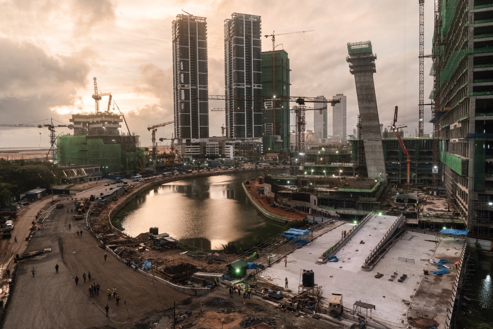 Chinese construction workers walk home from work at a development site in Colombo, Sri Lanka. — The New York Times