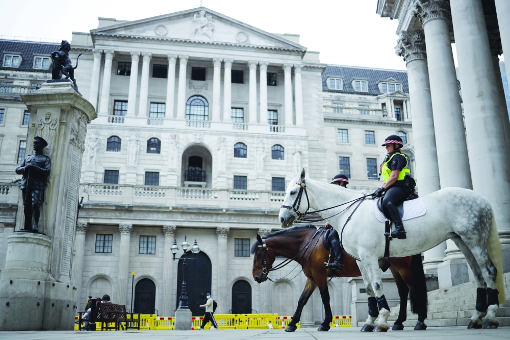 Mounted police officers sit in outside the Royal Exchange and the Bank of England in London. — Reuters