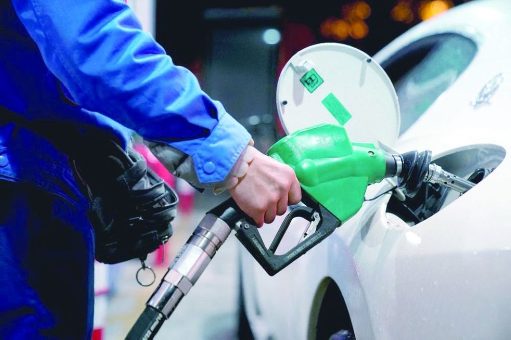 A gas station attendant pumps fuel into a customer's car at a gas station in Shanghai, China. — Reuters