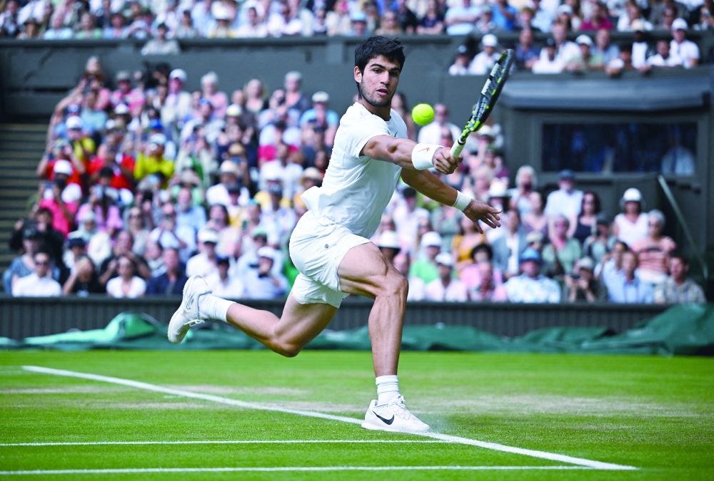 Tennis - Wimbledon - All England Lawn Tennis and Croquet Club, London, Britain - July 12, 2023 Spain's Carlos Alcaraz in action during his quarter final match against Denmark's Holger Rune REUTERS/Dylan Martinez
