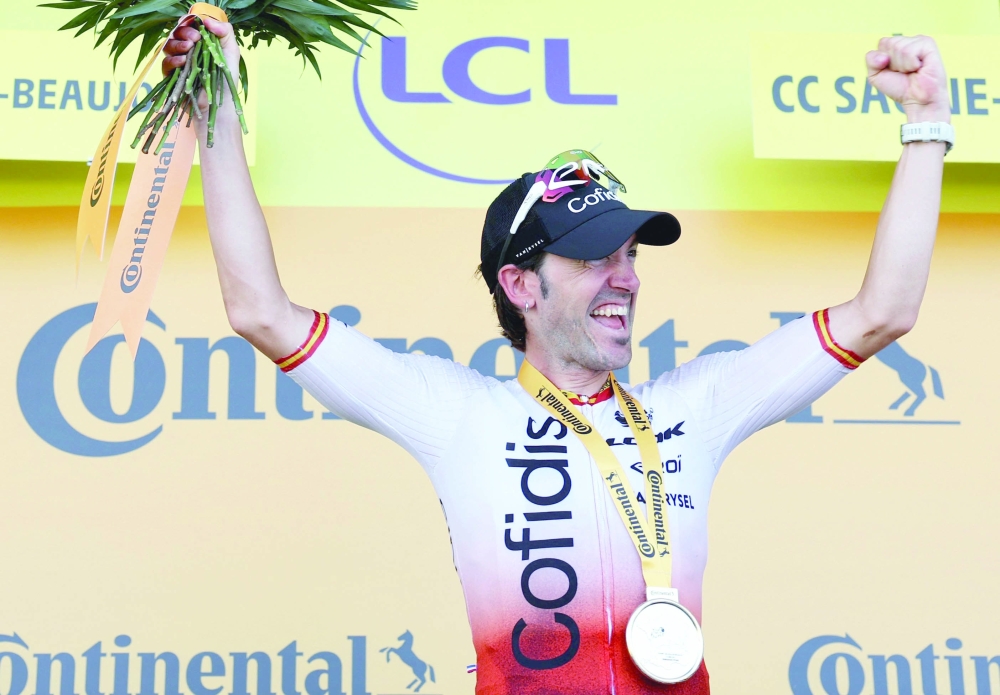 Cofidis' Spanish rider Ion Izaguirre Insausti celebrates his victory on the podium after winning the 12th stage of the 110th edition of the Tour de France cycling race, 169 km between Roanne and Belleville-en-Beaujolais, in central-eastern France, on July 13, 2023. (Photo by Thomas SAMSON / AFP)

