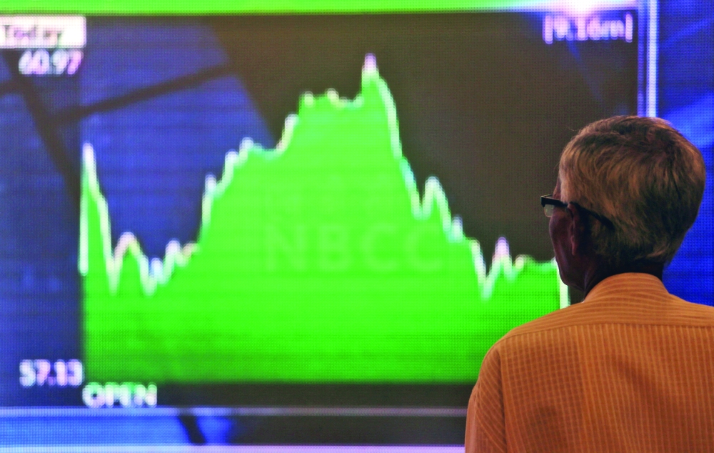 A man looks at a screen displaying news of markets update inside the Bombay Stock Exchange (BSE) building in Mumbai.- Reuters File


