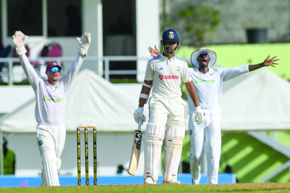 Yashasvi Jaiswal (C), of India, waits for the decision from the umpire as Joshua Da Silva (L) and Jason Holder (R), of West Indies, appeal for lbw during day two of the First Test between West Indies and India at Windsor Park in Roseau, Dominica, on July 13, 2023. (Photo by Randy Brooks / AFP)

