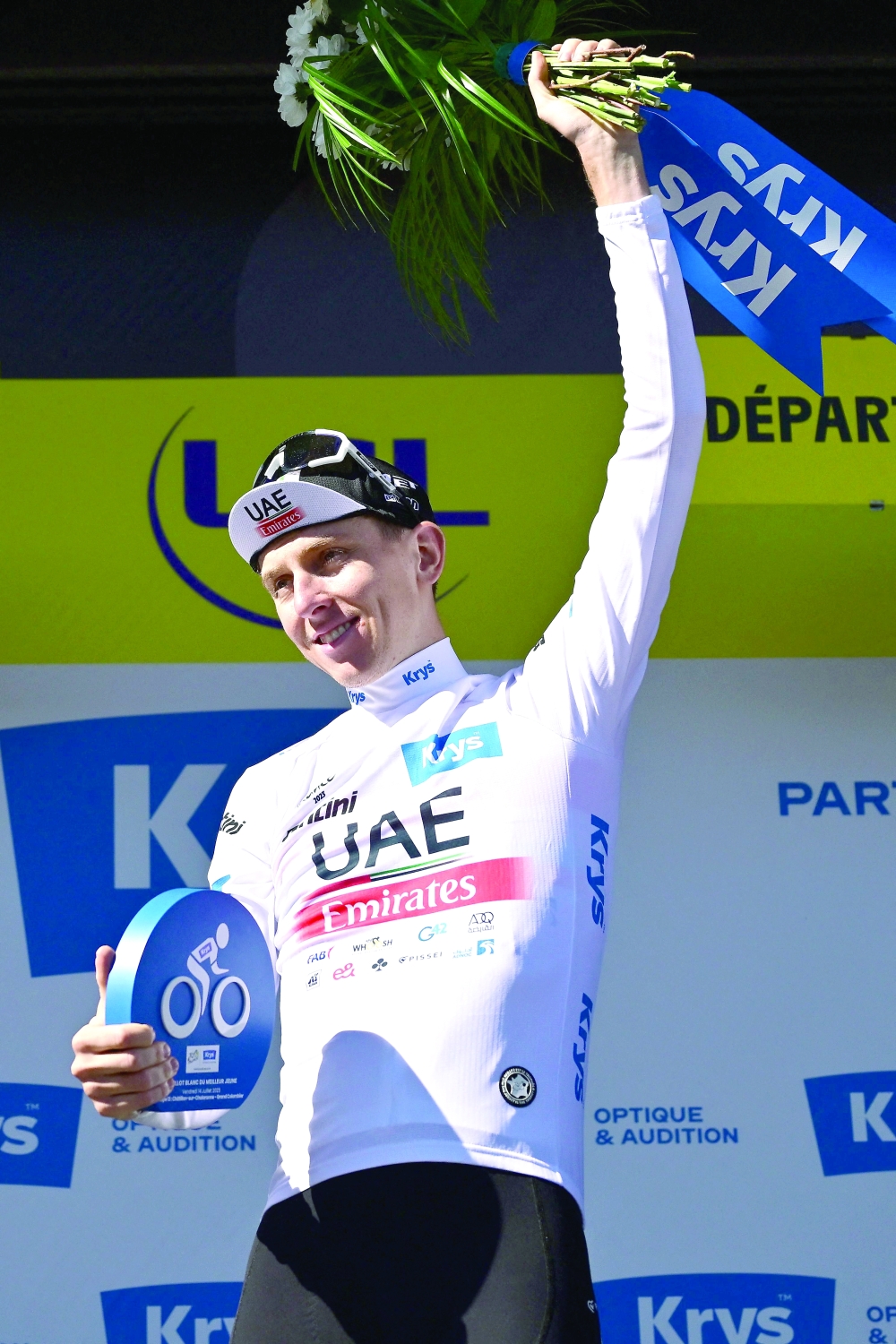 UAE Team Emirates' Slovenian rider Tadej Pogacar celebrates on the podium with the best young rider's white jersey after the 13th stage of the 110th edition of the Tour de France cycling race, 138 km between Chatillon-sur-Chalaronne in central-eastern France and Grand Colombier, in the Jura mountains in Eastern France, on July 14, 2023. (Photo by Marco BERTORELLO / AFP)

