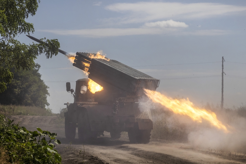 Ukrainian Marines from the 36th Brigade fire rockets from a Grad launcher toward Russian infantry in a frontline tree line position in the Zaporizhzhia region of Ukraine