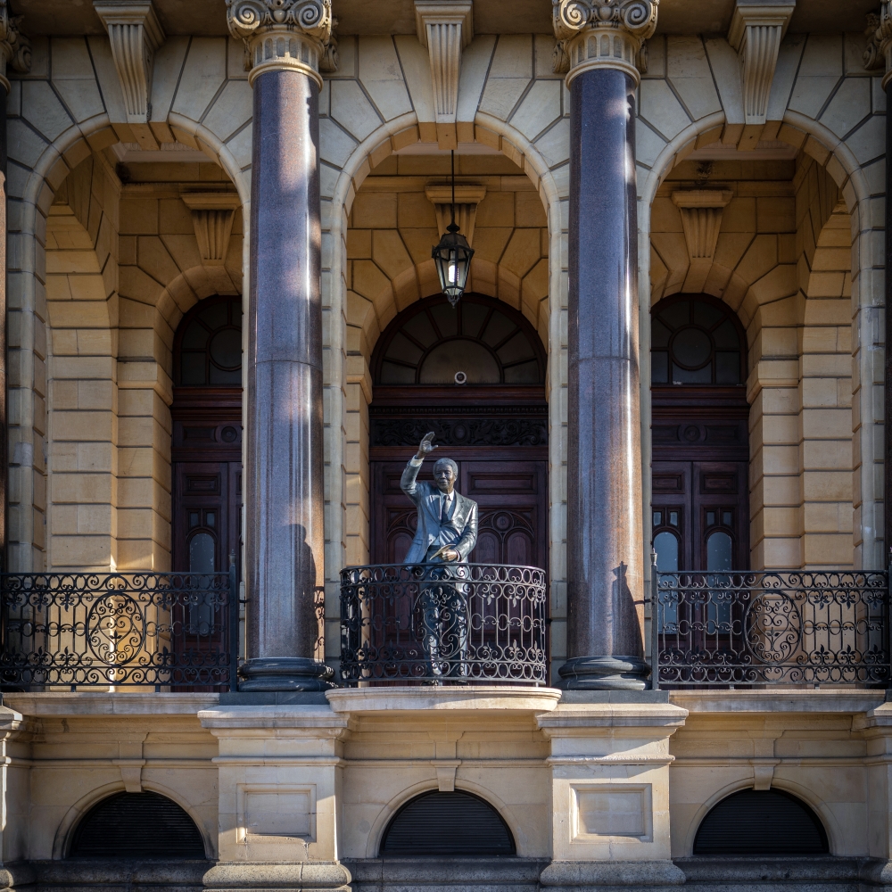 A statue depicting Nelson Mandela at the City Hall in Cape Town, South Africa, on July 11, 2023. Nearly two dozen statues in his image watch over a country in flux. (Gulshan Khan/The New York Times)
