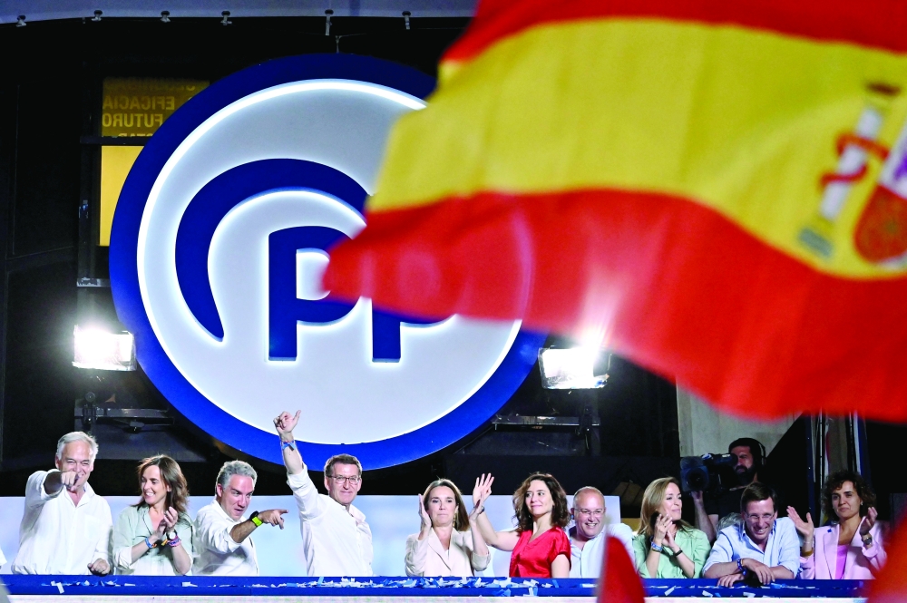 The leader and candidate of conservative Partido Popular as he addresses supporters from a balcony of the PP headquarters in Madrid.— Reuters
