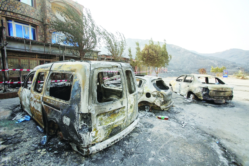 Burnt vehicles are pictured in the aftermath of a wildfire in Bejaia, Algeria. — Reuters 