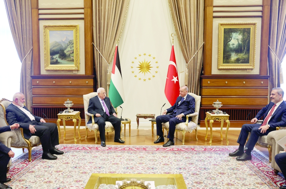 Turkiye's President Tayyip Erdogan and Turkish FM Hakan Fidan meet with Palestinian President Mahmoud Abbas and Palestinian group Hamas' top leader Ismail Haniyeh at the Presidential Palace in Ankara, Turkiye. — Reuters
