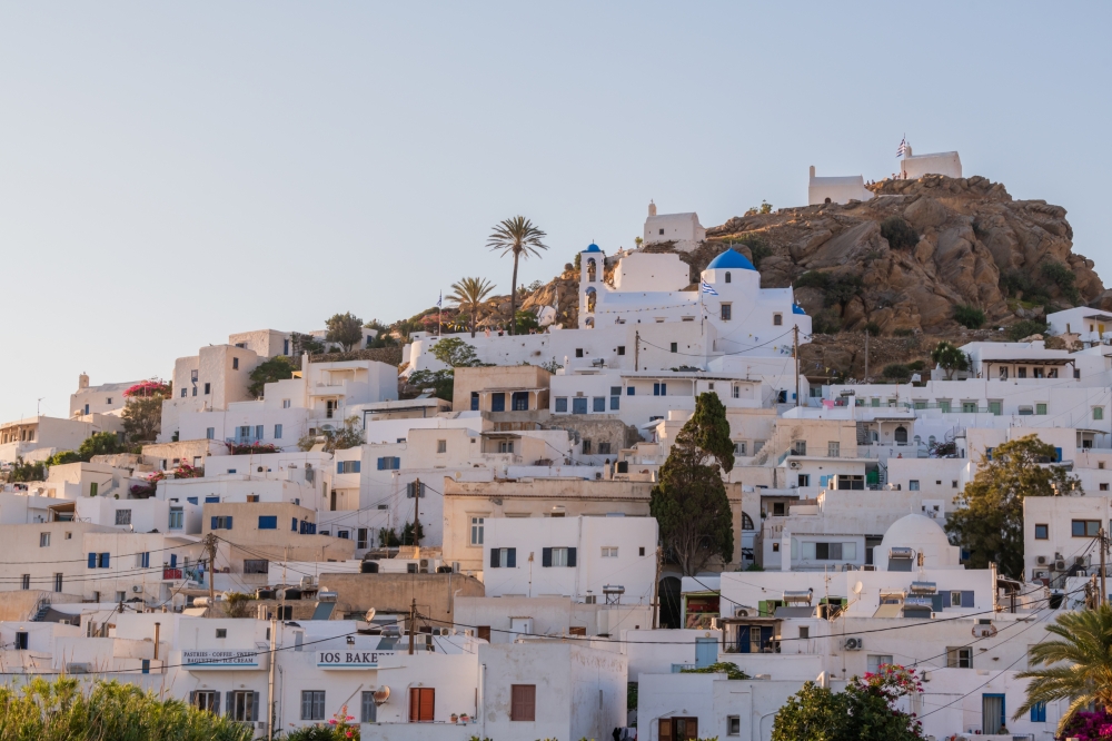 Homes with white-washed walls, which helps to keep the interiors cooler, in Chora, on the Mediterranean island of Ios, Greece, Aug. 10, 2022. (Maria Mavropoulou/The New York Times)