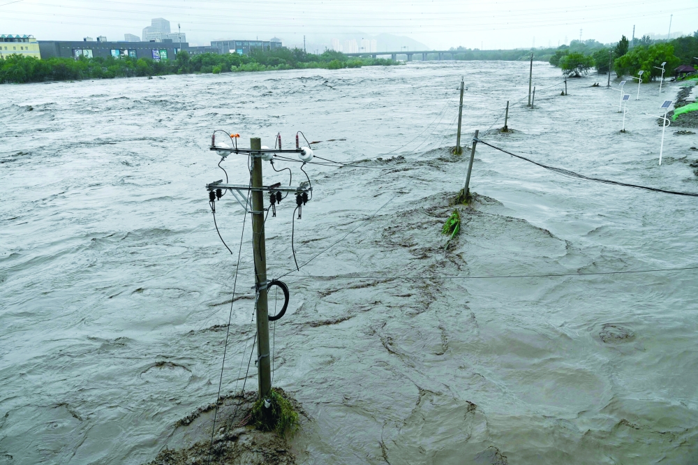 A view of the overflooded Yongding river, after heavy rains in Mentougou district in Beijing on Monday. — AFP