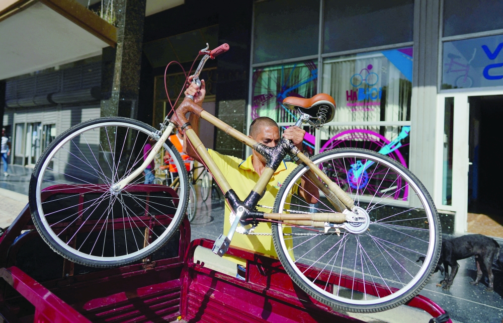 An employee of Velo Cuba unloads an eco-friendly bamboo bicycle in Havana, Cuba. - Reuters
